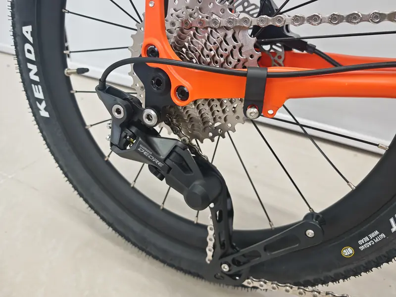 Shimano Deore rear derailleur and Kenda off-road tyre on an orange Leggero Explorer GS