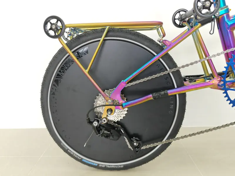 Carbon disc rear wheel on the oil-slick titanium bike