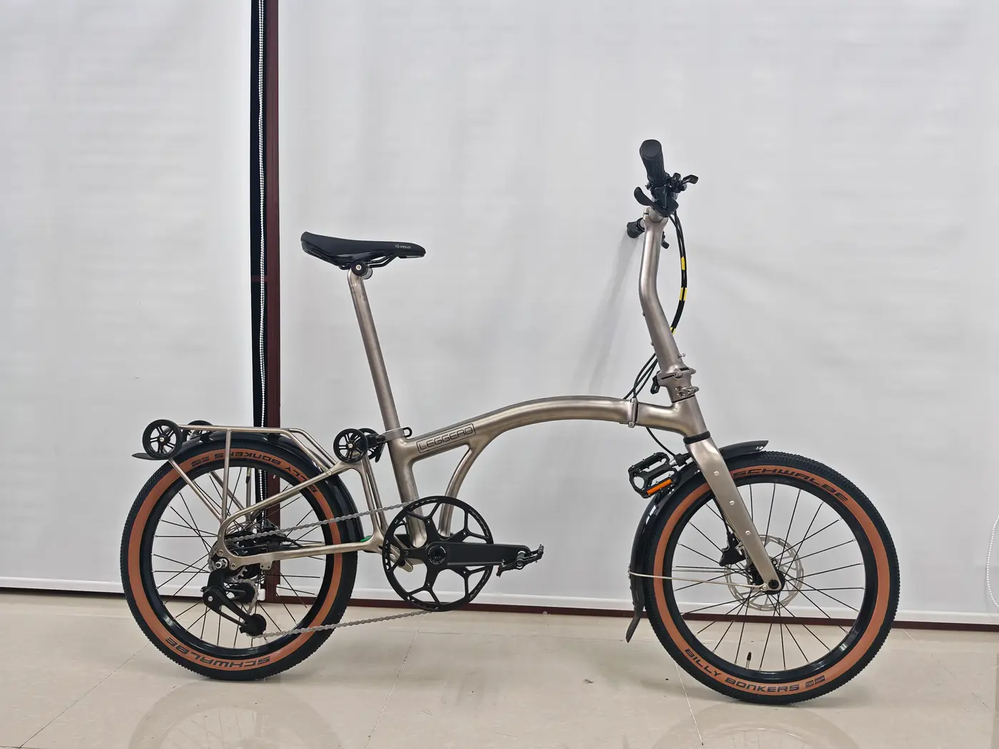 A Leggero Voyager GT with a raw 3D-printed titanium frame and tan-wall Schwalbe tyres, unfolded