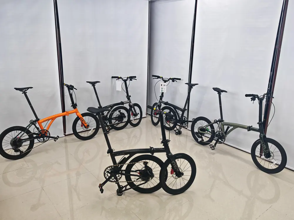 Five Java J-Air Carbon bikes on the showroom floor, in orange, black and olive green